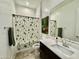 Clean bathroom with a vanity and a tub with a decorative shower curtain at 20171 W Cheery Lynn Rd, Buckeye, AZ 85396