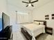 Cozy bedroom with a bed, dresser, and window at 20171 W Cheery Lynn Rd, Buckeye, AZ 85396