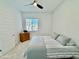 Bright bedroom with a ceiling fan, neutral walls, and a comfortable bed with a gray comforter at 20171 W Cheery Lynn Rd, Buckeye, AZ 85396