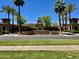 Inviting entrance to Verrado Golf Club, framed by majestic palm trees and manicured landscaping at 20171 W Cheery Lynn Rd, Buckeye, AZ 85396