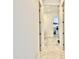 Hallway with carpet flooring and doorways leading to laundry room at 20171 W Cheery Lynn Rd, Buckeye, AZ 85396