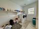 Functional laundry room with modern appliances and plenty of shelving for storage at 20171 W Cheery Lynn Rd, Buckeye, AZ 85396