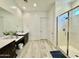 Bright main bathroom with dual sinks, a walk-in shower, and tile floors at 20171 W Cheery Lynn Rd, Buckeye, AZ 85396