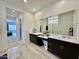 Lovely main bathroom with dual sinks, a makeup vanity, and a frameless shower at 20171 W Cheery Lynn Rd, Buckeye, AZ 85396