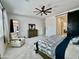 Comfortable main bedroom with a ceiling fan and a sliding barn door to the ensuite bath at 20171 W Cheery Lynn Rd, Buckeye, AZ 85396