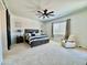 Spacious main bedroom with a ceiling fan, a comfortable chair, and a barn door at 20171 W Cheery Lynn Rd, Buckeye, AZ 85396