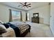 Bright main bedroom features a ceiling fan, soft carpet, and a door to the backyard at 20171 W Cheery Lynn Rd, Buckeye, AZ 85396