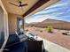 Cozy covered patio with comfortable seating overlooking a low-maintenance backyard with desert landscaping at 20171 W Cheery Lynn Rd, Buckeye, AZ 85396