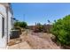 Backyard with gravel ground covering, mature bushes, and greenery, is perfect for outdoor enjoyment at 205 S Higley Rd # 300, Mesa, AZ 85206