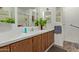 Bright bathroom with wood cabinets, vanity, and a tile surround shower and bathtub at 205 S Higley Rd # 300, Mesa, AZ 85206
