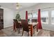 Cozy dining room featuring a decorative ceiling fan, a marble table, and bright windows dressed with curtains at 205 S Higley Rd # 300, Mesa, AZ 85206