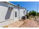 View of the exterior shows a white mobile home with a door and an air conditioner at 205 S Higley Rd # 300, Mesa, AZ 85206