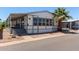 Charming single-story home featuring large windows, a covered porch and a beautifully landscaped yard with a mature palm tree at 205 S Higley Rd # 300, Mesa, AZ 85206