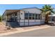 Charming single-story home featuring large windows, a covered porch and a beautifully landscaped yard with a mature palm tree at 205 S Higley Rd # 300, Mesa, AZ 85206