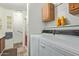 Laundry room with appliances, storage and sink offers convenience for laundry tasks at 205 S Higley Rd # 300, Mesa, AZ 85206