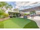 Lush backyard featuring a putting green, fireplace, and seating area perfect for enjoying the outdoors at 21231 E Nightingale Rd, Queen Creek, AZ 85142