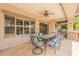 Covered backyard patio with ceiling fan and an outdoor dining area at 21231 E Nightingale Rd, Queen Creek, AZ 85142