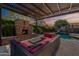Relaxing backyard with a fireplace, covered patio, and pool, creating an ideal outdoor retreat at 21231 E Nightingale Rd, Queen Creek, AZ 85142