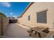 Spacious backyard area featuring a concrete surface and wooden picnic table at 21231 E Nightingale Rd, Queen Creek, AZ 85142