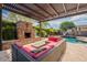 Stunning backyard featuring a covered patio, fireplace, seating area, and swimming pool with a slide for entertainment at 21231 E Nightingale Rd, Queen Creek, AZ 85142