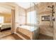 Bathroom with a soaking tub and a stand-up shower with access to the main bedroom at 21231 E Nightingale Rd, Queen Creek, AZ 85142