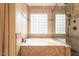 Bathroom with a soaking tub and a stand-up shower with a tile surround at 21231 E Nightingale Rd, Queen Creek, AZ 85142