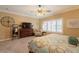 Comfortable bedroom features a dresser with TV and an armchair with side table at 21231 E Nightingale Rd, Queen Creek, AZ 85142
