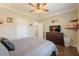 Neutral bedroom showcasing furniture and decor, including a TV and ceiling fan at 21231 E Nightingale Rd, Queen Creek, AZ 85142