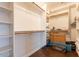 Walk-in closet featuring built-in shelving and wood floors at 21231 E Nightingale Rd, Queen Creek, AZ 85142