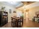 Inviting dining area with wood-look tile flooring, decorative lighting, and adjacent hallway at 21231 E Nightingale Rd, Queen Creek, AZ 85142