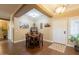Cozy dining area featuring wood floors, a table with four chairs, and decorative wall art at 21231 E Nightingale Rd, Queen Creek, AZ 85142