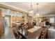 Open-concept space featuring dining room, kitchen with granite countertops, and living room at 21231 E Nightingale Rd, Queen Creek, AZ 85142