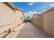 Long driveway between two houses showing a picnic table in the distance at 21231 E Nightingale Rd, Queen Creek, AZ 85142