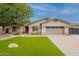 Charming single-story home with well-manicured lawn, mature tree, and two-car garage at 21231 E Nightingale Rd, Queen Creek, AZ 85142