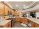Kitchen with granite countertops, stainless steel appliances, and wood cabinets at 21231 E Nightingale Rd, Queen Creek, AZ 85142