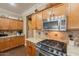 Kitchen with stainless steel appliances, granite countertops and wood cabinets at 21231 E Nightingale Rd, Queen Creek, AZ 85142