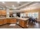Open kitchen with stainless steel appliances, wood cabinets and breakfast bar at 21231 E Nightingale Rd, Queen Creek, AZ 85142