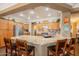Open kitchen with stainless steel appliances, granite countertops, breakfast bar and wood cabinets at 21231 E Nightingale Rd, Queen Creek, AZ 85142