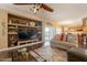 Bright, open living area with wood floors, comfortable seating, and a built-in media center at 21231 E Nightingale Rd, Queen Creek, AZ 85142