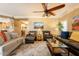 Spacious living room with tile floors, comfortable seating, and an adjacent dining and kitchen area at 21231 E Nightingale Rd, Queen Creek, AZ 85142