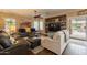 Comfortable living room with plush seating, ceiling fan, and built-in shelving at 21231 E Nightingale Rd, Queen Creek, AZ 85142