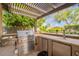 Outdoor kitchen with stainless steel grill, cabinets, and counter space at 21231 E Nightingale Rd, Queen Creek, AZ 85142