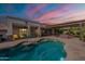 Stunning backyard featuring a pool, covered patio, and lounge area perfect for outdoor entertaining at 21231 E Nightingale Rd, Queen Creek, AZ 85142