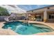 Backyard pool with slide, hot tub, and lounge chairs creates a relaxing outdoor oasis for Gathering and friends at 21231 E Nightingale Rd, Queen Creek, AZ 85142