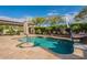 Inviting backyard pool featuring a slide, basketball hoop, and serene landscaping, creating a perfect oasis for relaxation at 21231 E Nightingale Rd, Queen Creek, AZ 85142