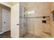 Tiled shower featuring a glass door, seat, and tiled fixtures at 21231 E Nightingale Rd, Queen Creek, AZ 85142