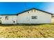 Simple back exterior view showcasing the home's white stucco and backyard space at 214 W June Cir, Mesa, AZ 85201