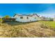 Backyard featuring the home, fence, and a hammock stand, all under a clear blue sky at 214 W June Cir, Mesa, AZ 85201