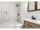 Bathroom with white marble-look tile tub surround, and light wood vanity at 214 W June Cir, Mesa, AZ 85201