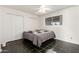 Bedroom with a dark tile floor, and a queen-sized bed under a ceiling fan and window at 214 W June Cir, Mesa, AZ 85201